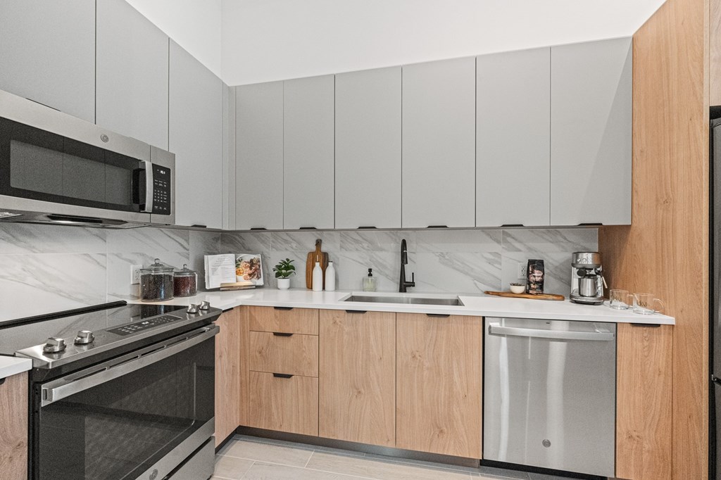 A modern kitchen with wooden cabinets and stainless steel appliances.