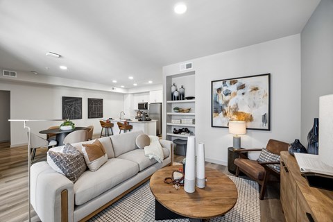 A modern living room with a white sofa and a wooden coffee table.