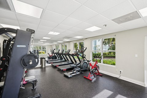 A spacious gym with a variety of equipment including treadmills, weights, and exercise machines.