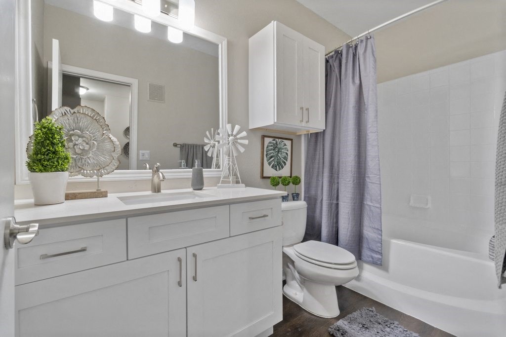 Bathroom with Soaking Tub, White Marble Countertop, and Custom White Cabinetry with Soft-Close Doors and Drawers