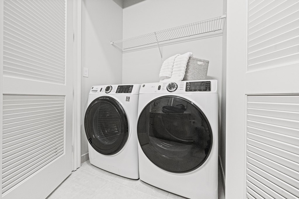 Two front loading washing machines in a laundry room.