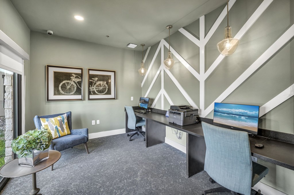 a home office with a desk and two computer monitors