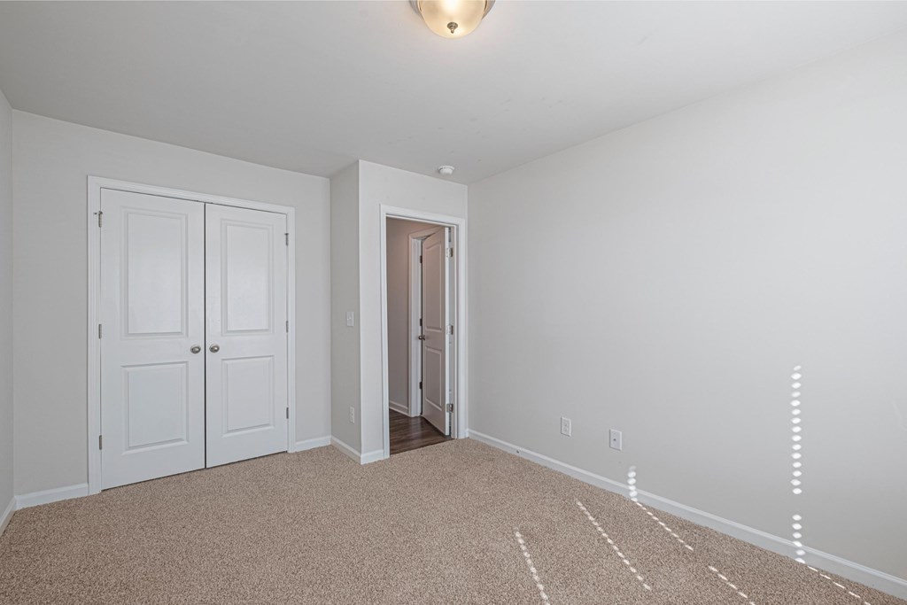 a bedroom with two closets and a door to a hallway