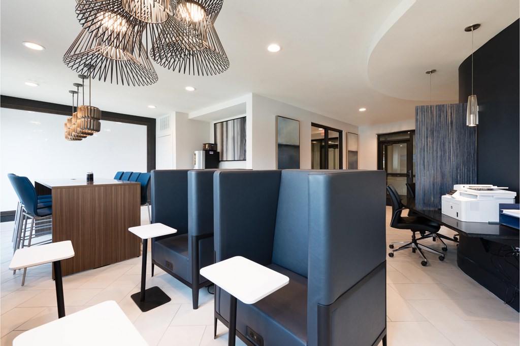 a restaurant with blue booths and white tables and chairs