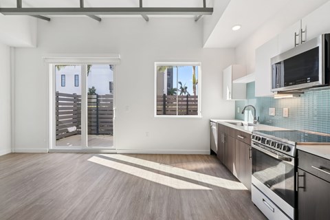 A kitchen with a stainless steel oven and microwave.