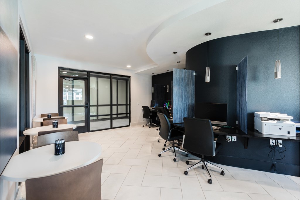 a conference room with tables and chairs and a black and white office space