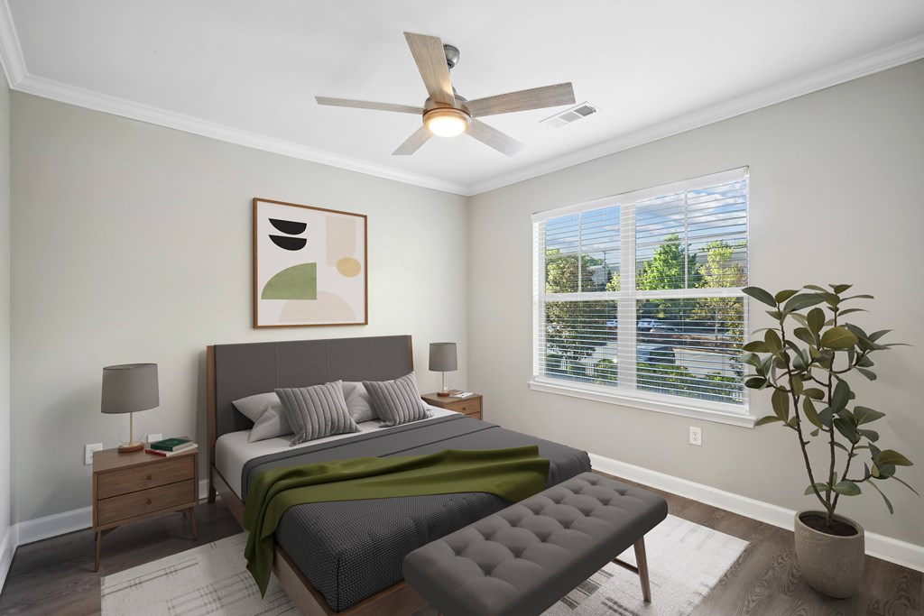 a bedroom with a large bed and a ceiling fan