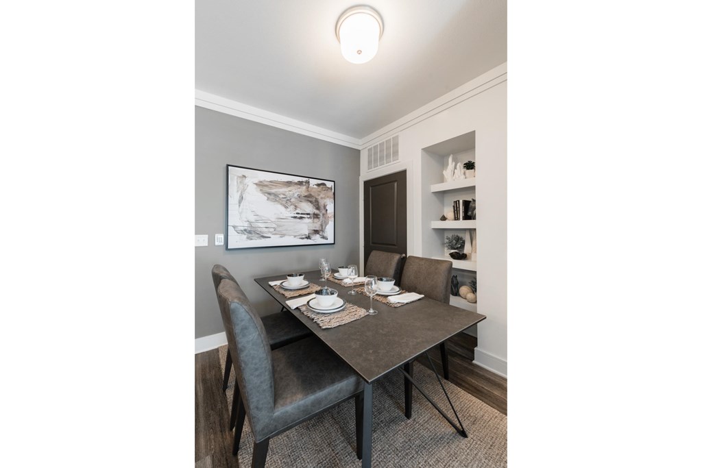 a dining room with a table and chairs