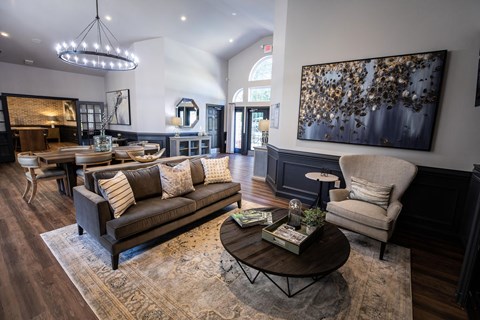 A living room with a brown leather couch and a coffee table.