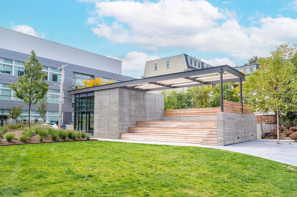 A modern building with a concrete staircase leading to a covered entrance.