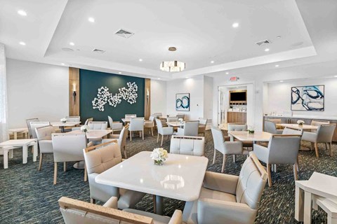 a dining room with tables and chairs and a large chalkboard in a conference room