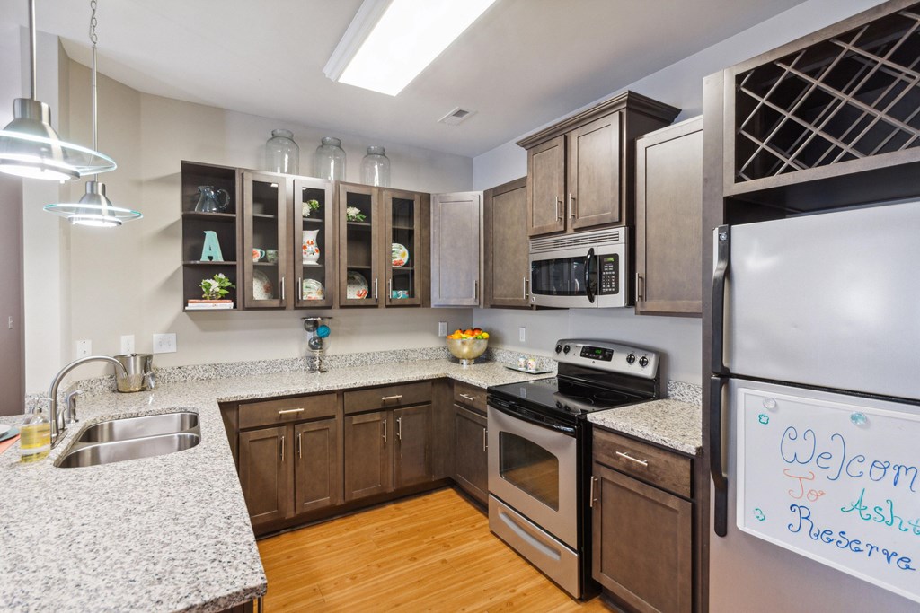 a kitchen with wooden cabinets and granite countertops