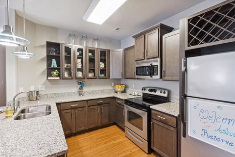 a kitchen with stainless steel appliances and granite counter tops