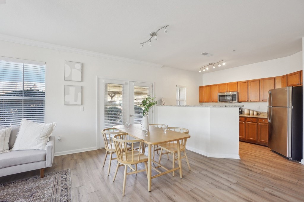 A modern kitchen with a dining table and chairs.