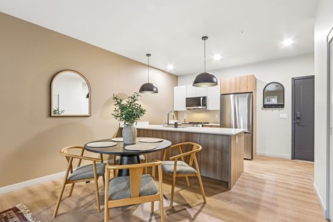 A kitchen with a round table and chairs.