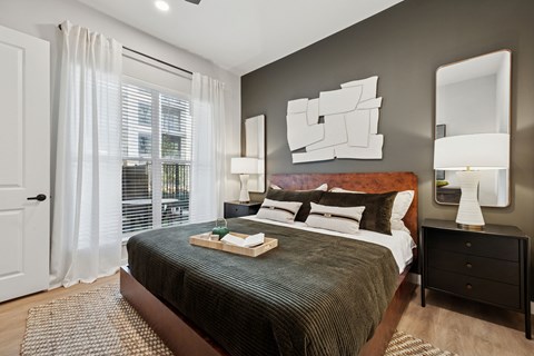 A bedroom with a large bed and a mirror on the wall.