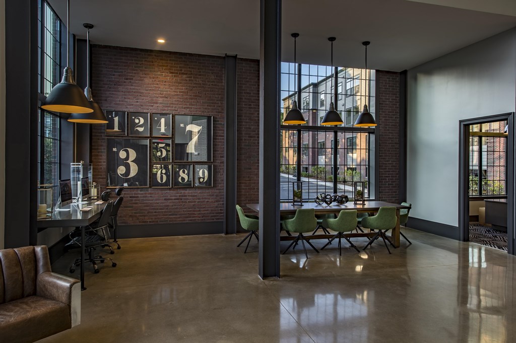 A modern dining room with a brick wall and a table set for six.