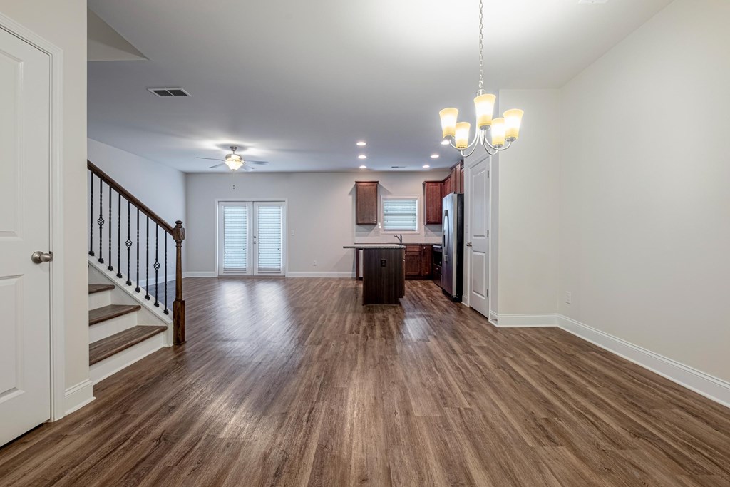 a living room with a hard wood floor and a staircase
