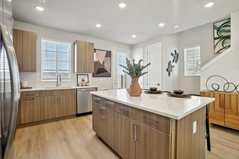 A kitchen with wooden cabinets and a white countertop.