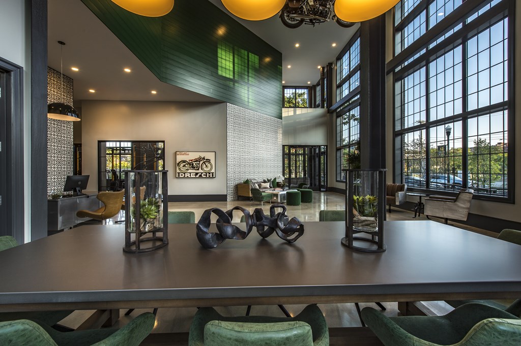 A modern dining room with a long table and chairs.