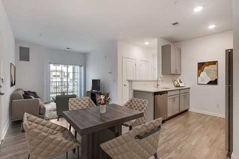 A dining room with a table and chairs.