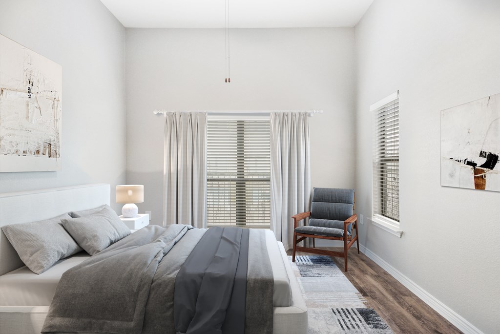 a bedroom with a bed and a chair and a window