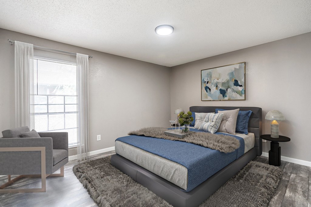 a bedroom with a bed and a chair