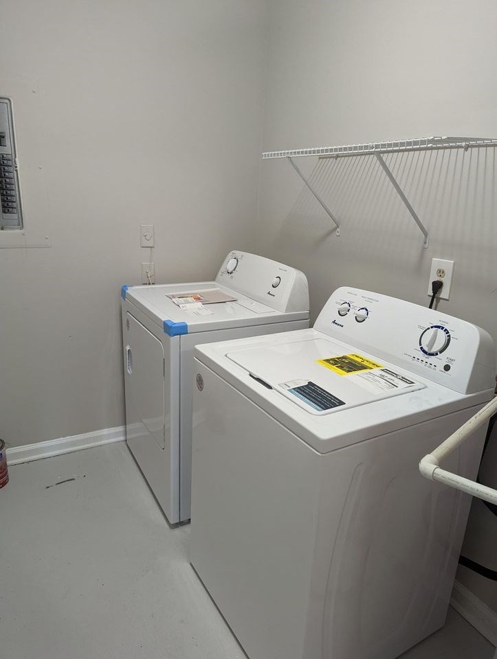 a bathroom with white cabinets and a sink and a shower