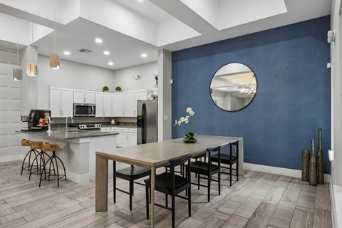 A kitchen with a table and chairs in the middle of the room.