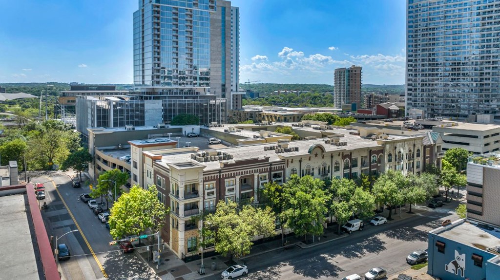 an aerial view of a city with tall buildings and trees