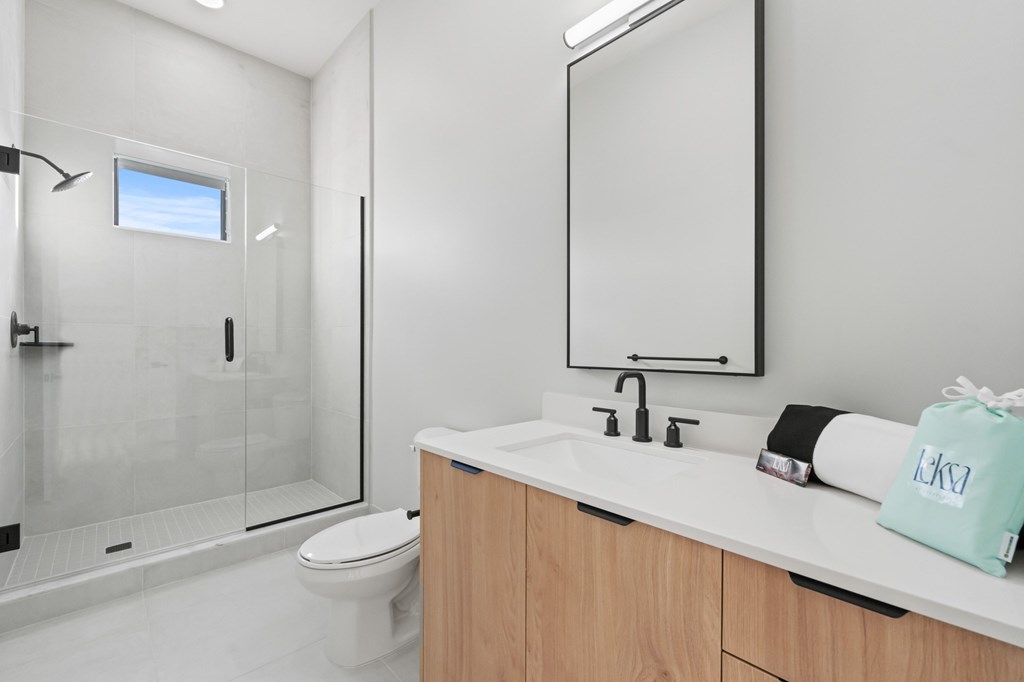 A Penthouse modern bathroom with a white countertop and a white toilet.