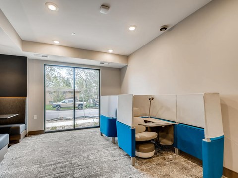 A room with a carpeted floor and a large window.