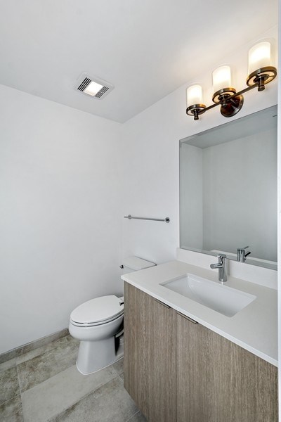 a bathroom with a toilet and a sink and a mirror