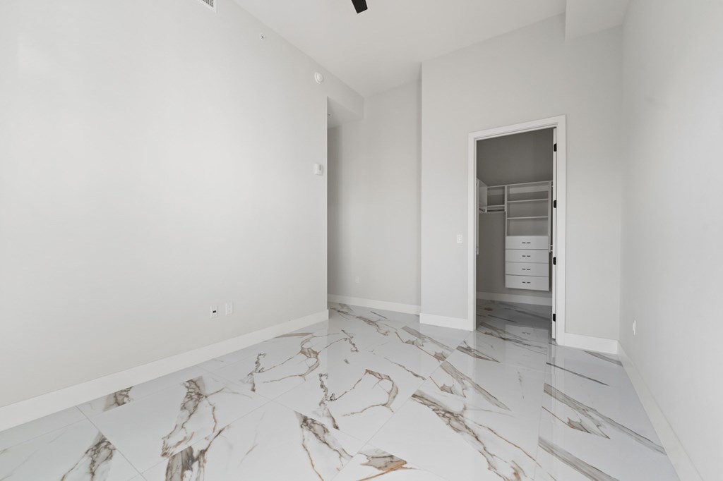Penthouse floorplan with upgraded fixtures and Marble-effect porcelain flooring and custom closets