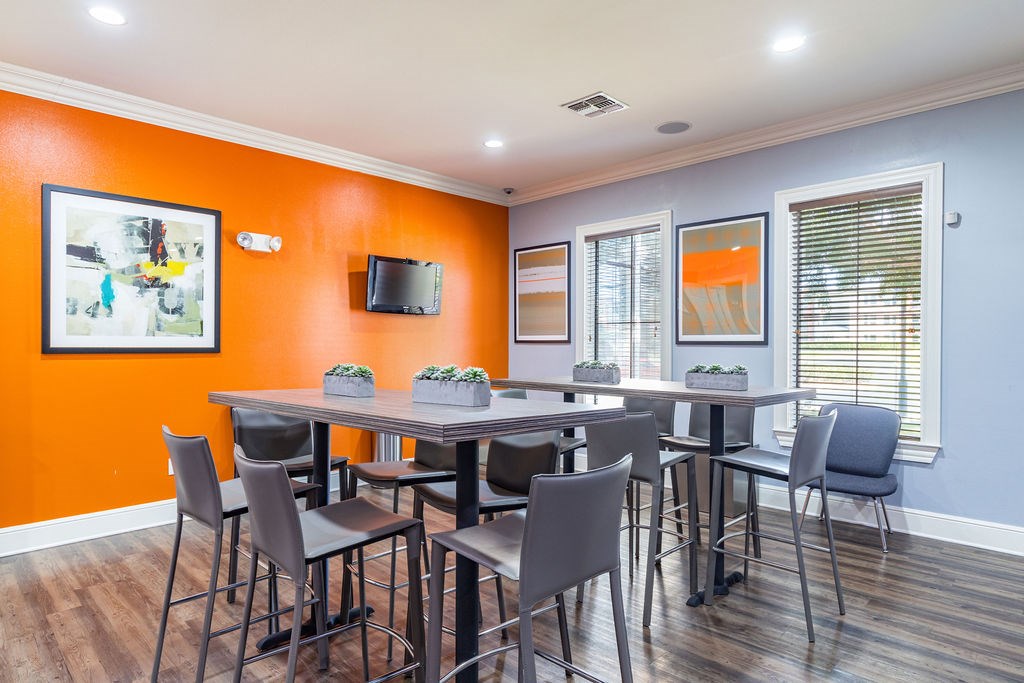 A dining room with a table and chairs.