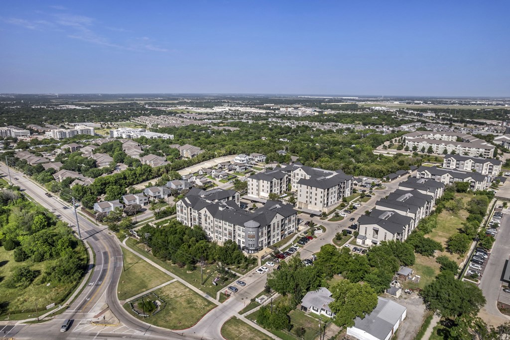 an aerial view of a city with houses and trees
