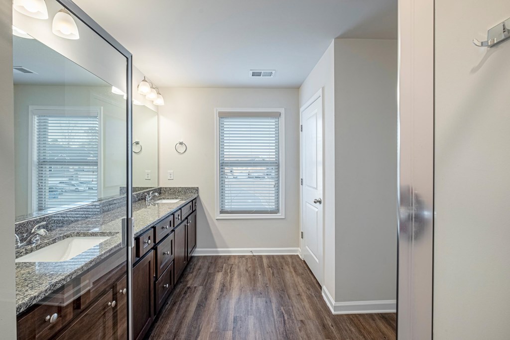 a bathroom with a large mirror and a sink and a shower