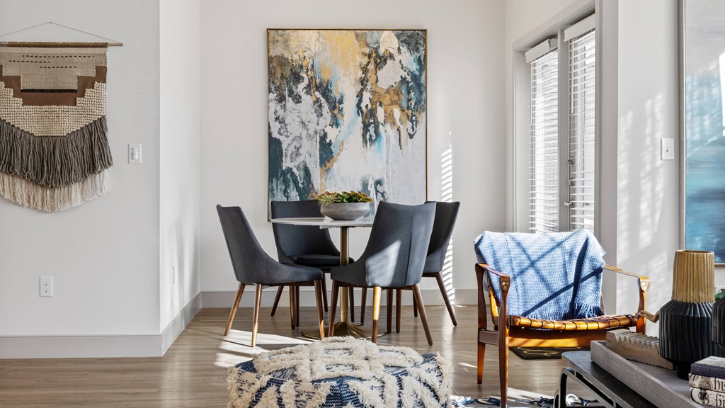 View of dining room nook from living room with large windows