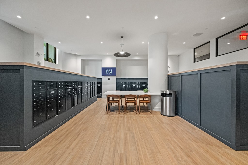 A long hallway with a table and chairs in the middle.