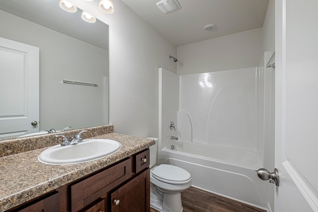 a bathroom with a sink and a toilet and a shower