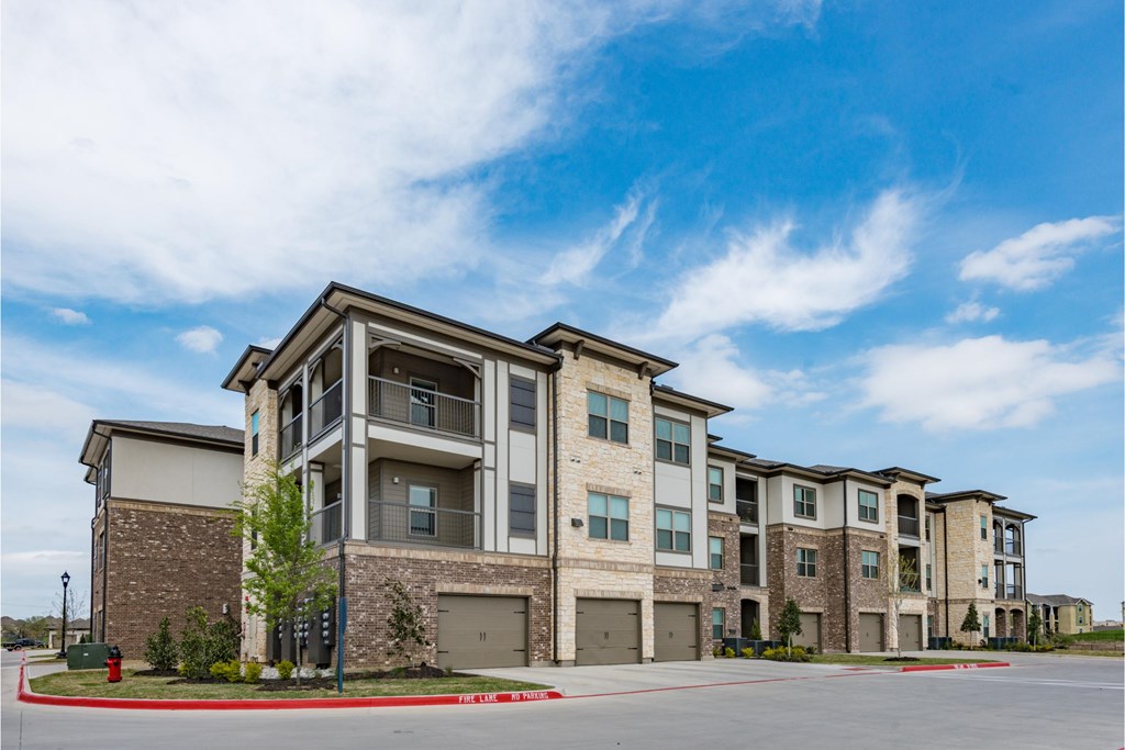 a row of apartment buildings with a blue sky in the background