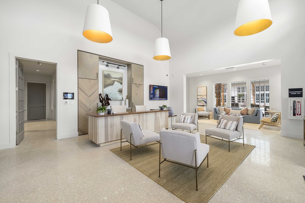 a lobby with chairs and a reception desk