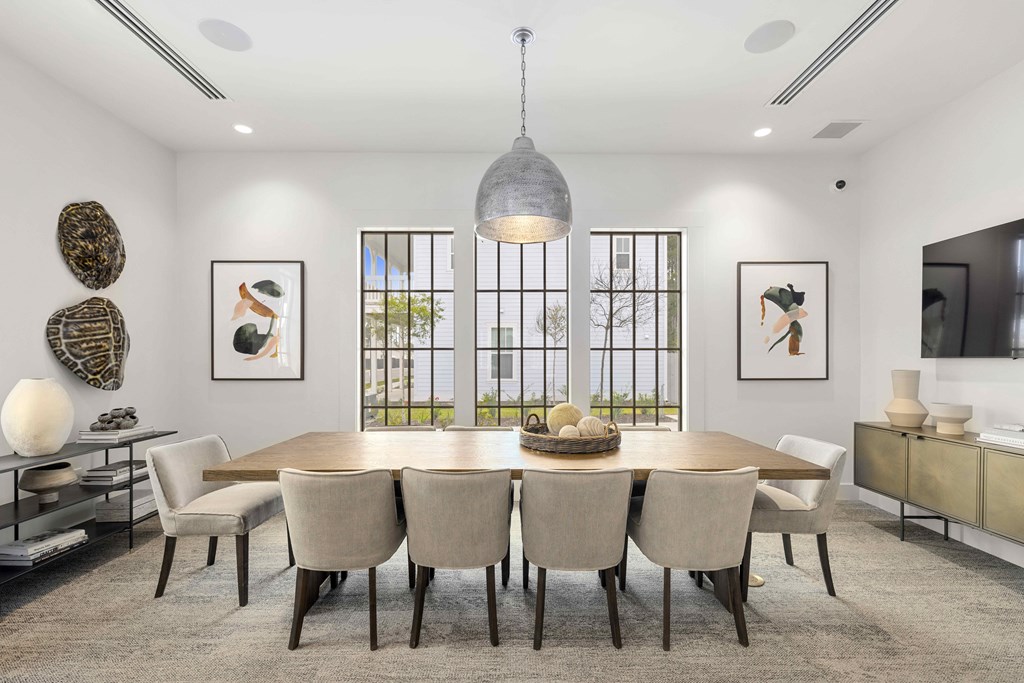 a dining room with a table and chairs and a large window