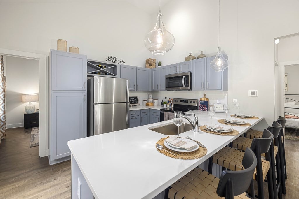 a kitchen with stainless steel appliances and a white counter top