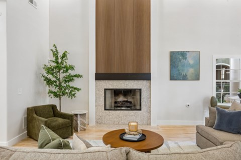 A living room with a fireplace and a painting on the wall.