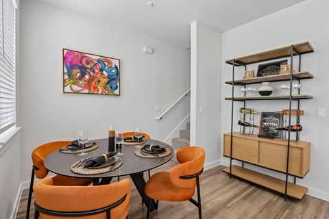 A dining room with a round table set for four.