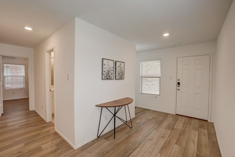 Brightly illuminated entrance seamlessly connecting to various parts of the home, creating an inviting and accessible ambiance throughout the space