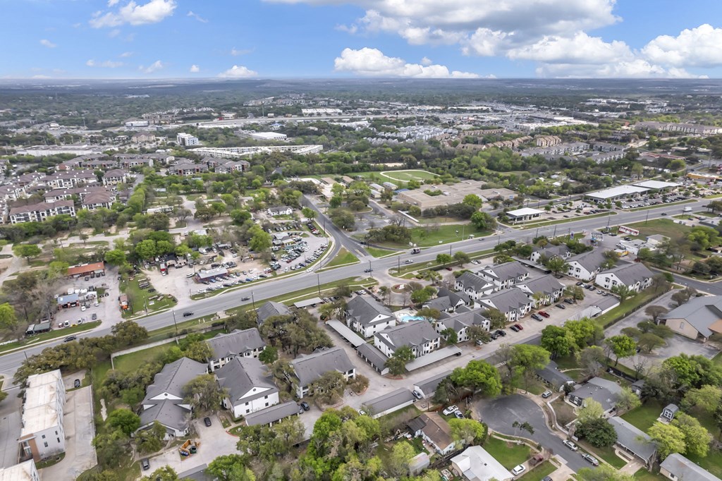 an aerial view of a city with many houses and trees