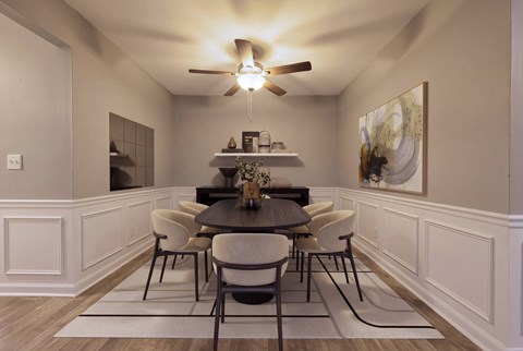 A dining room with a table set for six.