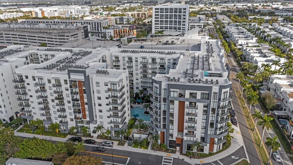 A large apartment complex with a pool in the middle.